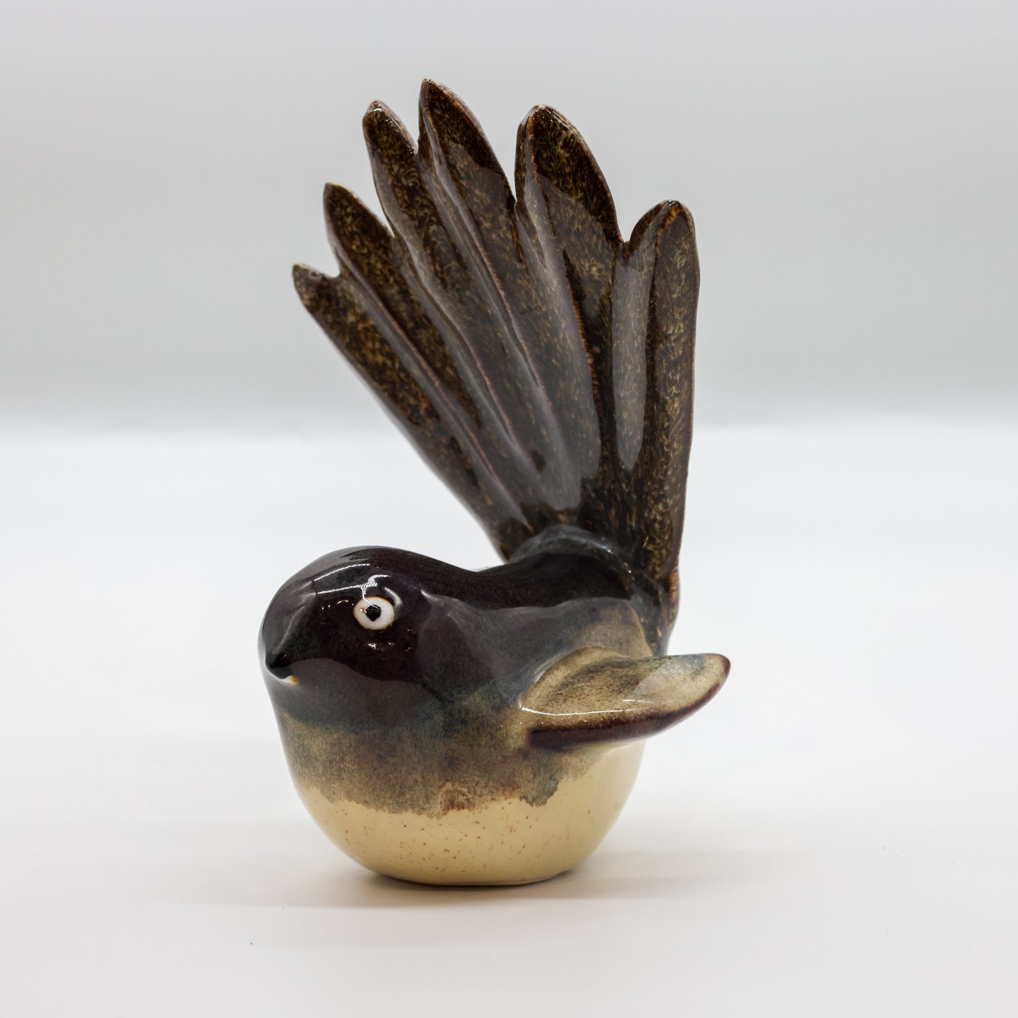Pīwakawaka ceramic sculpture, alternate angle showing porcelain glaze