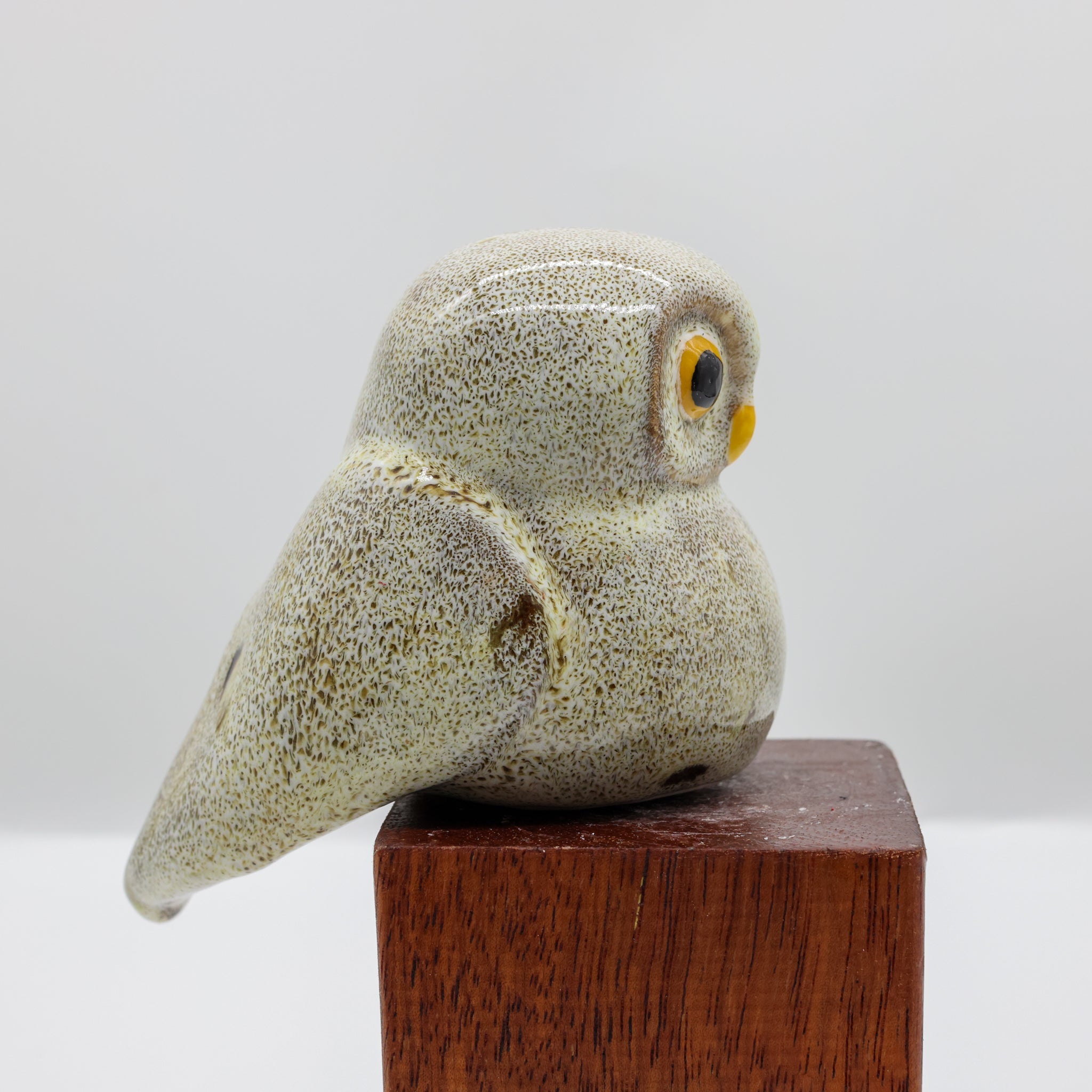 Ruru ceramic sculpture displayed on a wooden surface