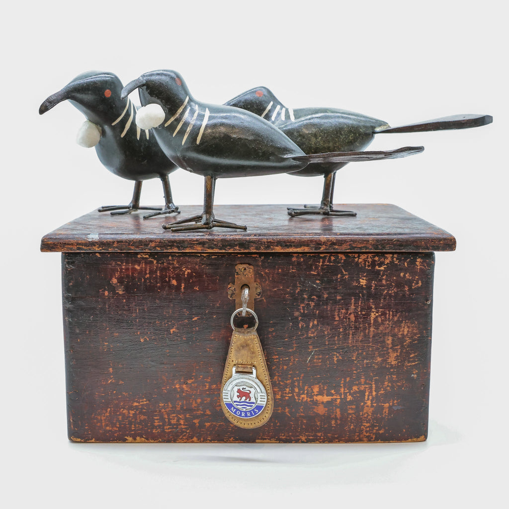 Stone Tūī sculpture front view, New Zealand songbird carving