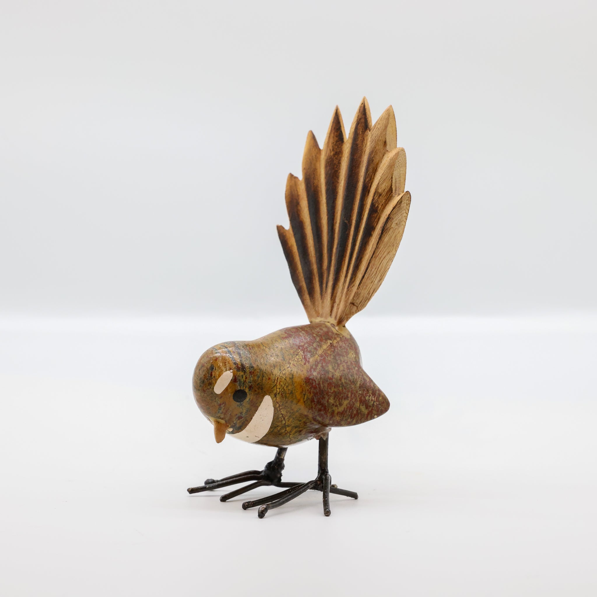 Stone Pīwakawaka sculpture front view, New Zealand fantail carving
