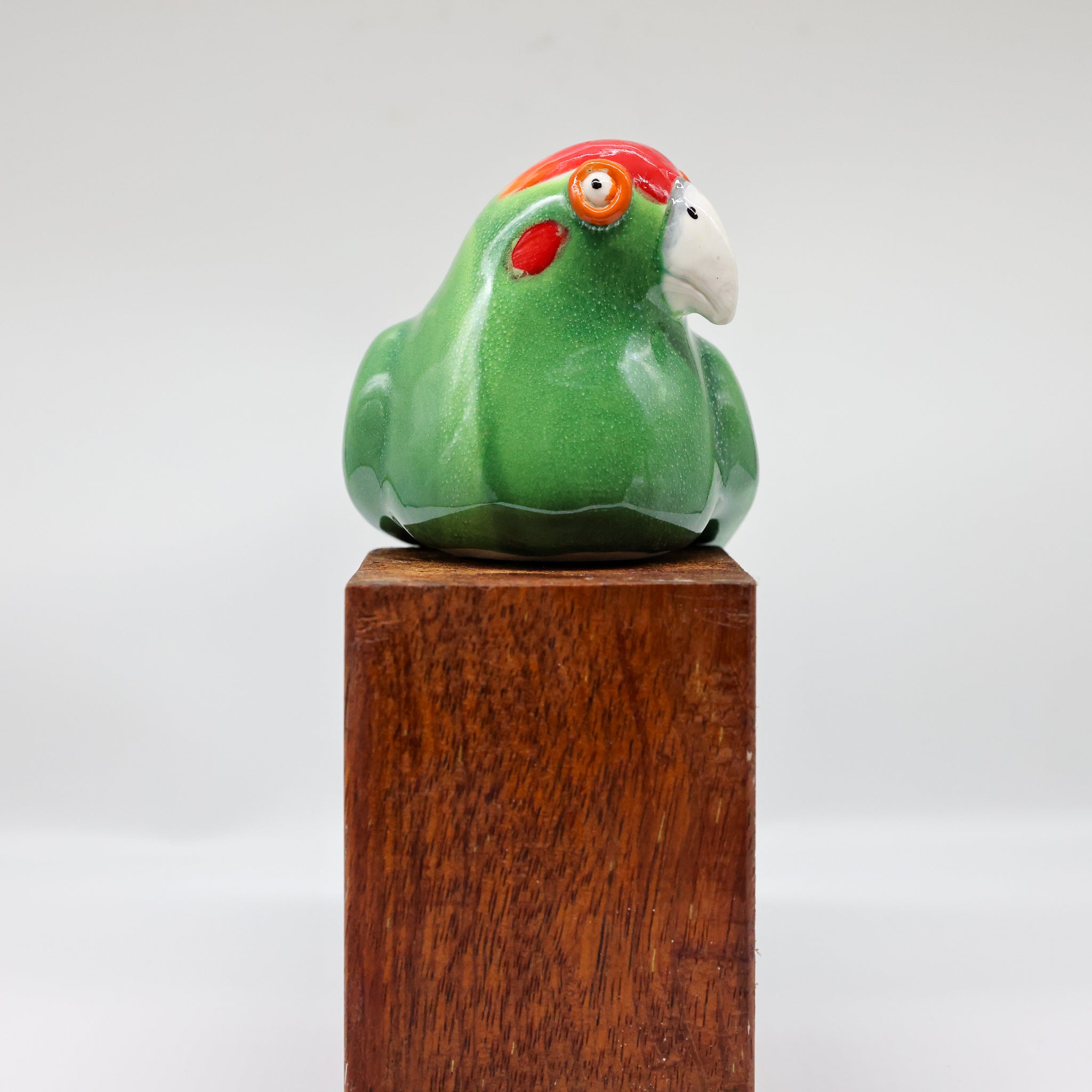 Kākāriki ceramic sculpture, alternate angle showing porcelain glaze