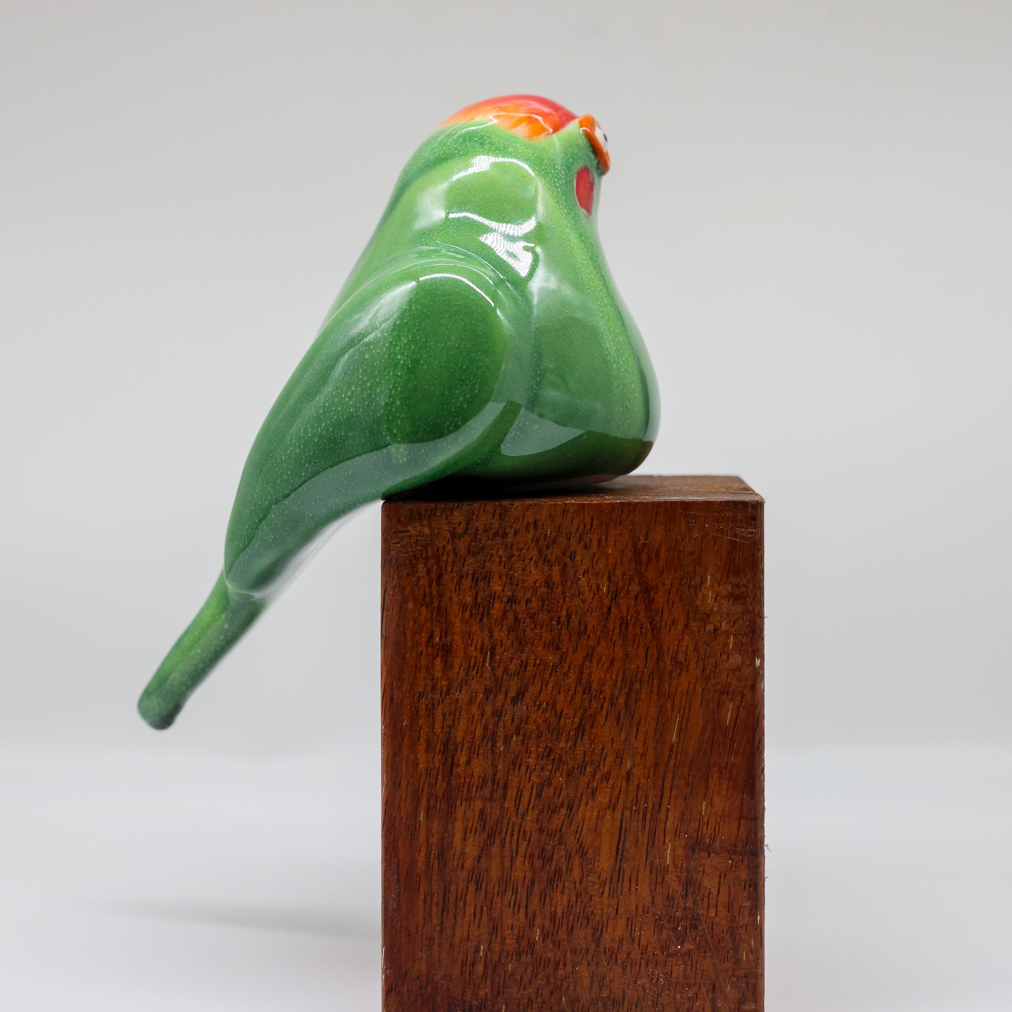 Kākāriki ceramic sculpture front view, green parakeet ornament
