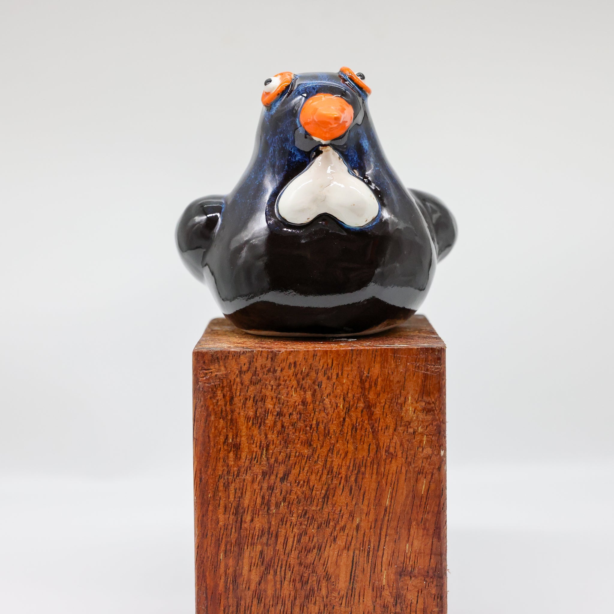 Tūī ceramic sculpture, alternate angle showing porcelain glaze