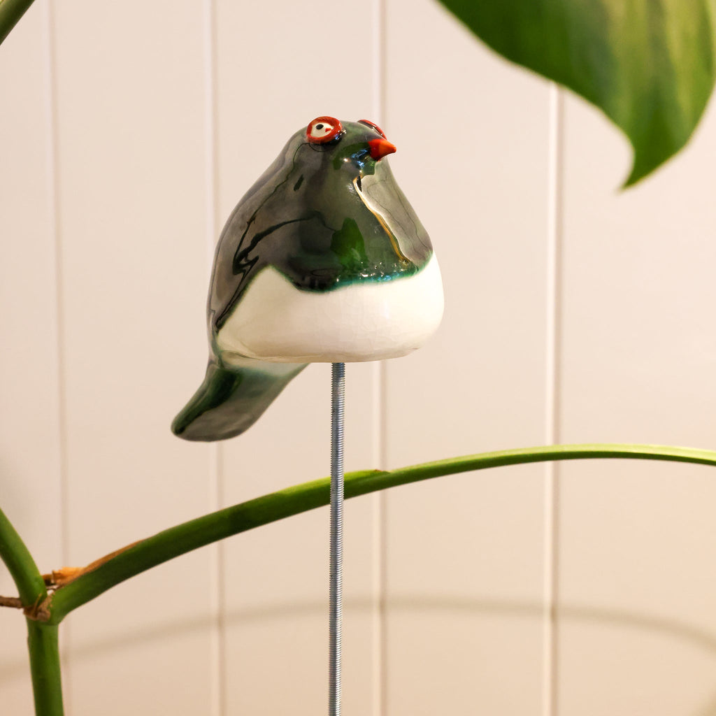 Kererū ceramic sculpture displayed on a wooden surface